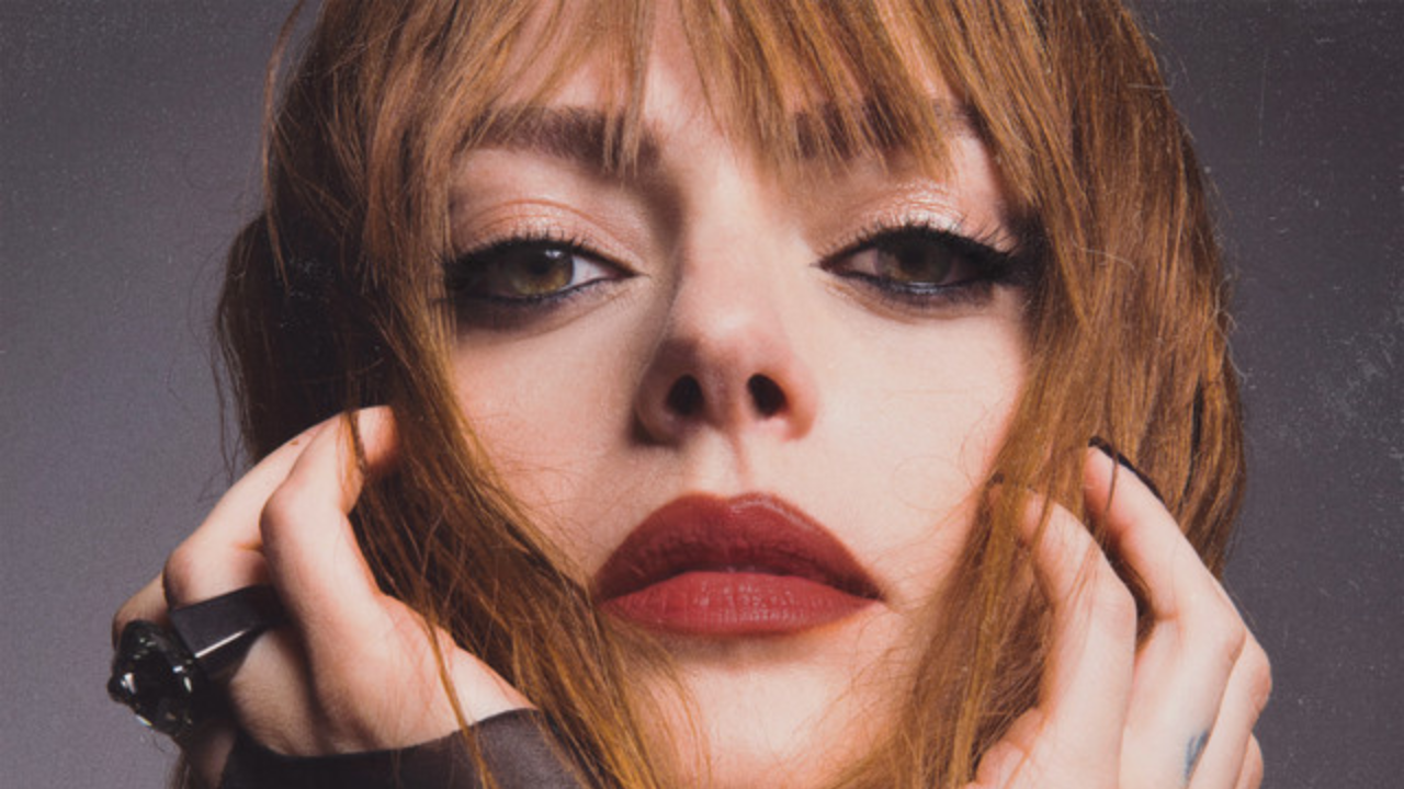 Annalisa wearing red lipstick leaning on her arms.