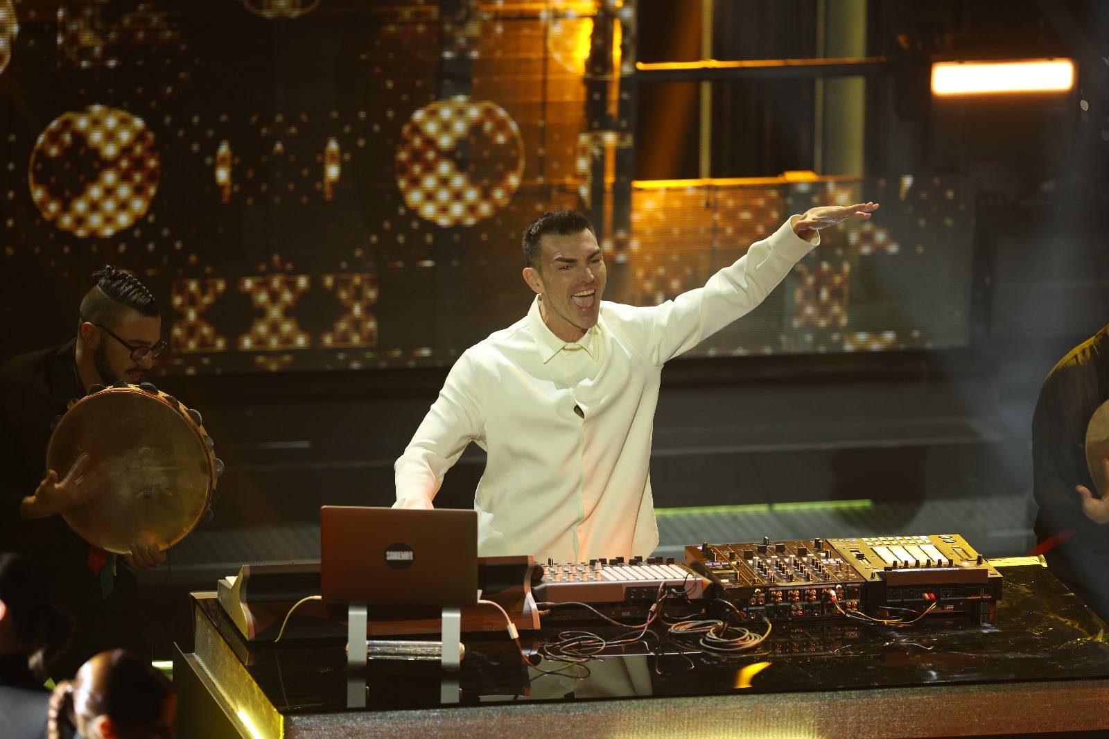 Gabry Ponte performing from behind a DJ desk.