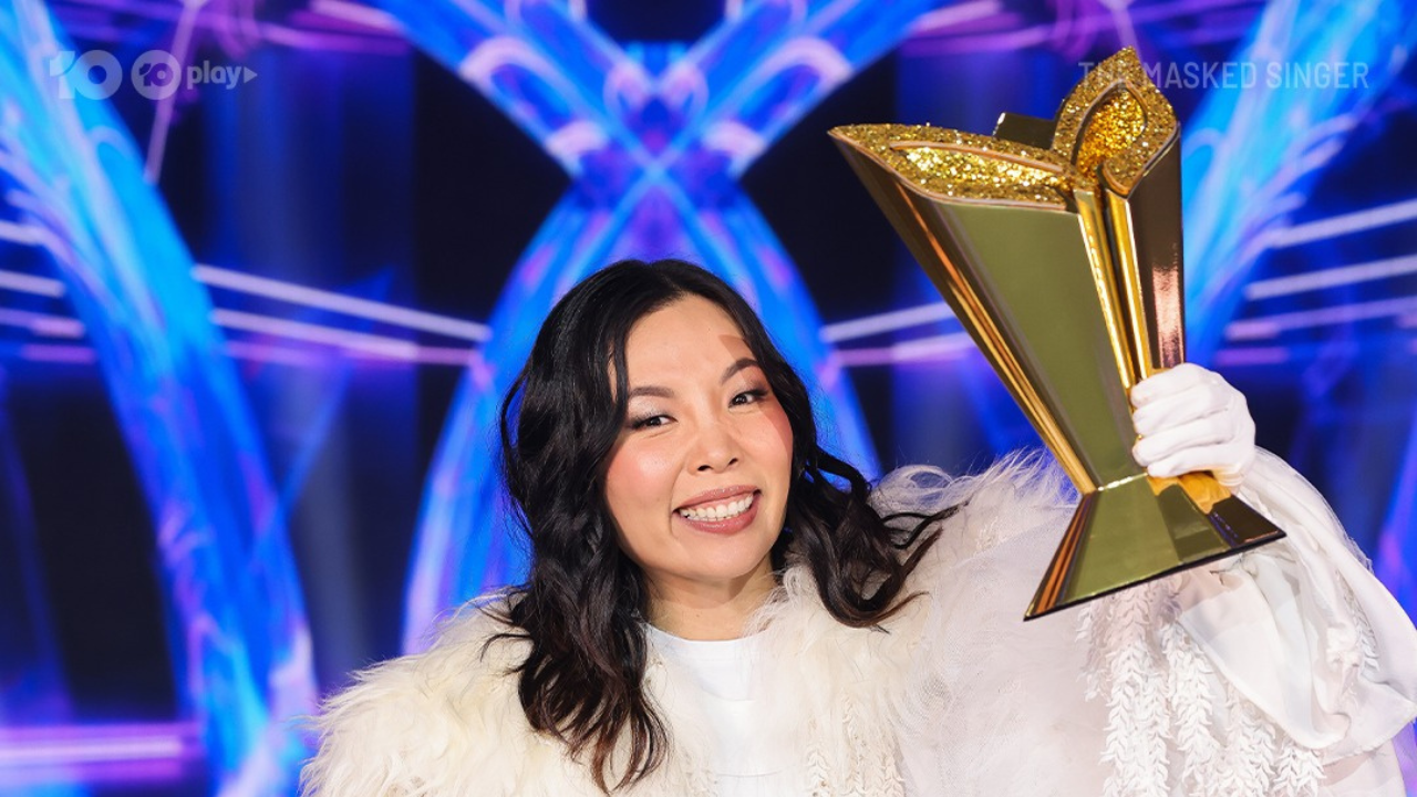 Dami Im holding the trophy for Masked Singer Australia
